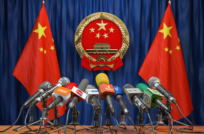 Rueda de prensa oficial del régimen o del líder de China. Banderas de China y micrófonos.